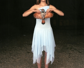 Laura McPhee<br /> <em>Mattie with a Northern Red-Shafted Flicker in Her Eigth Grade Graduation Dress, Laverty Ranch, Idaho, March 2005</em><br /> Digital chromogenic print<br /> 30 x 40” &nbsp; &nbsp;Edition of 5<br /> 50 x 60” &nbsp; &nbsp;Edition of 5<br /> 72 x 96” &nbsp; &nbsp;Edition of 5